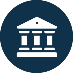 White classical government or bank building icon with three columns on a dark blue circular background.