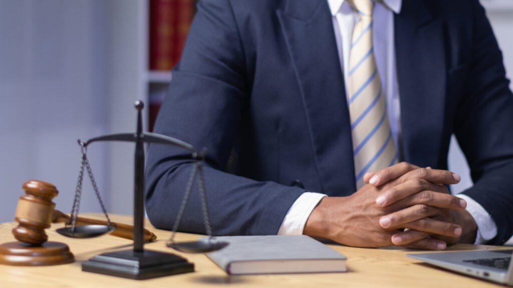 Attorney at desk with scales and gavel