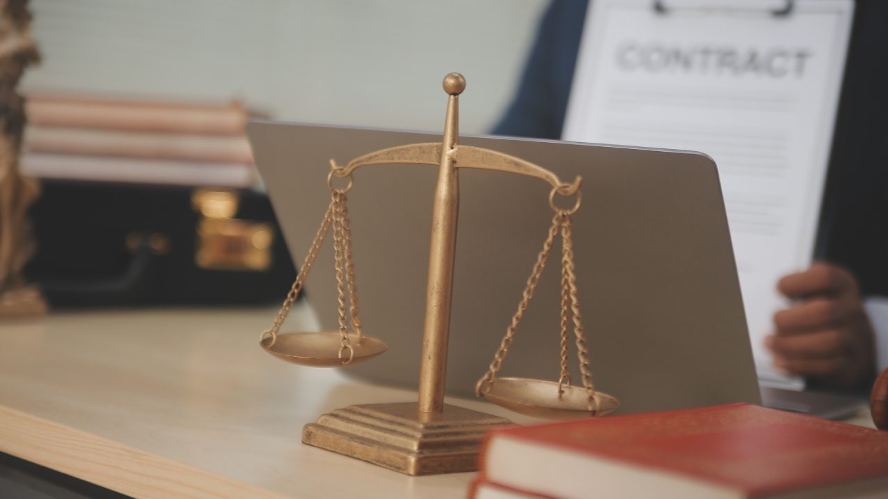 Brass scales of justice on office desk