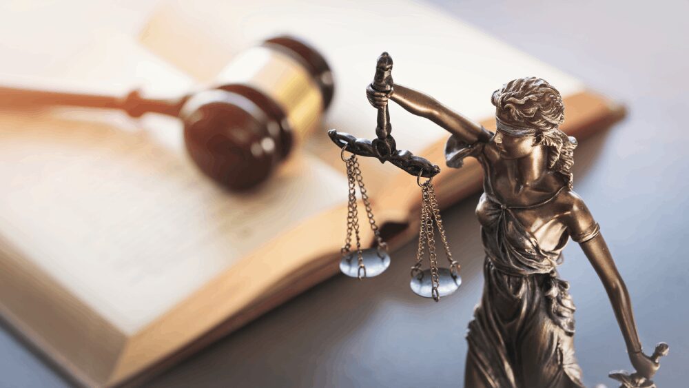 Lady Justice statue with scales, gavel, book