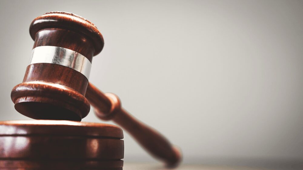 Wooden judge gavel on sounding block