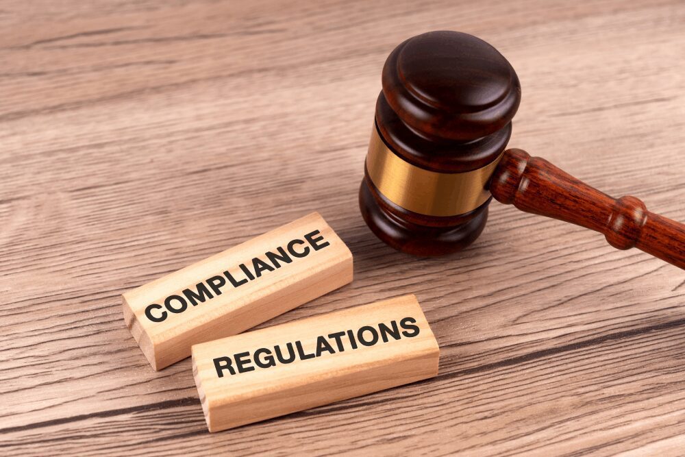 Wooden gavel with compliance and regulations blocks
