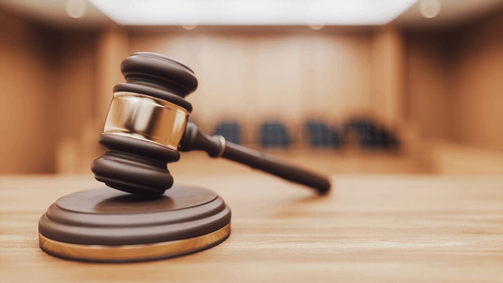 Wooden judge's gavel on courtroom bench