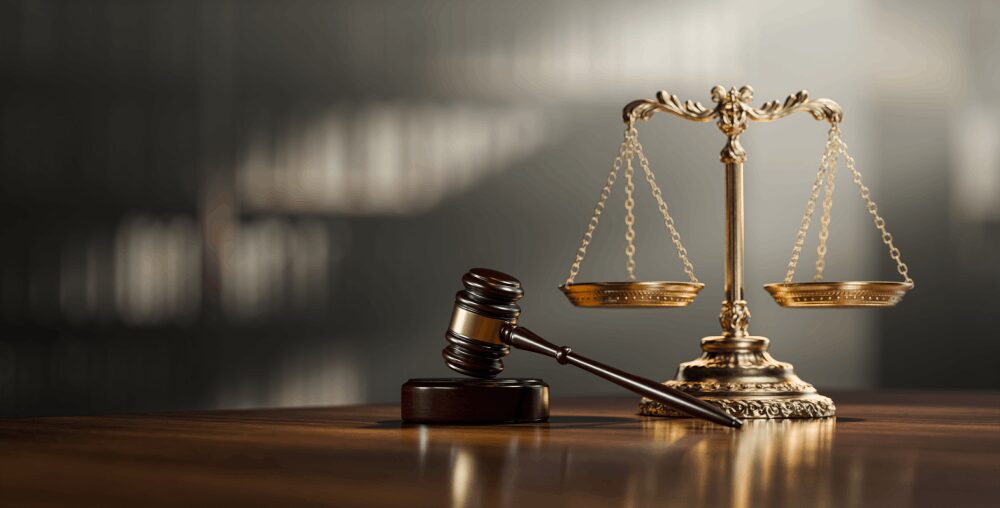 Gavel and brass scales of justice on table